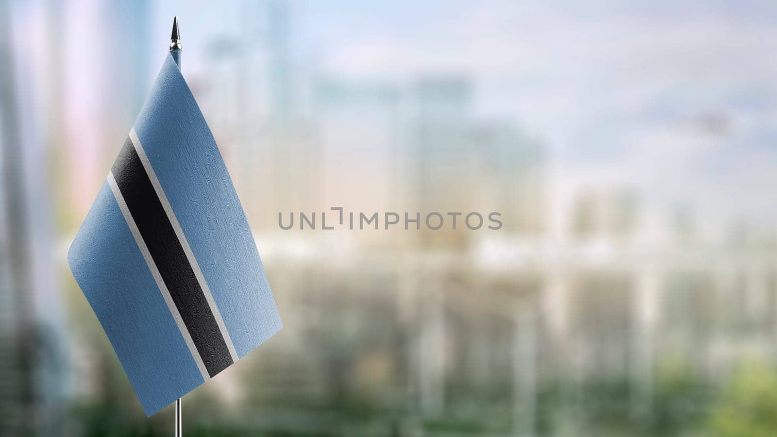 Small flags of the Botswana on an abstract blurry background.