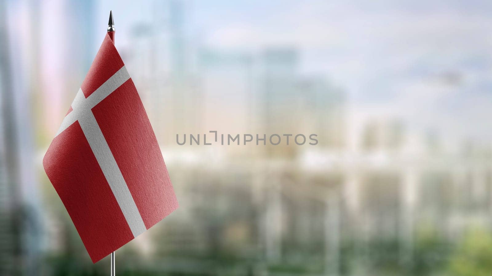 Small flags of the Denmark on an abstract blurry background.