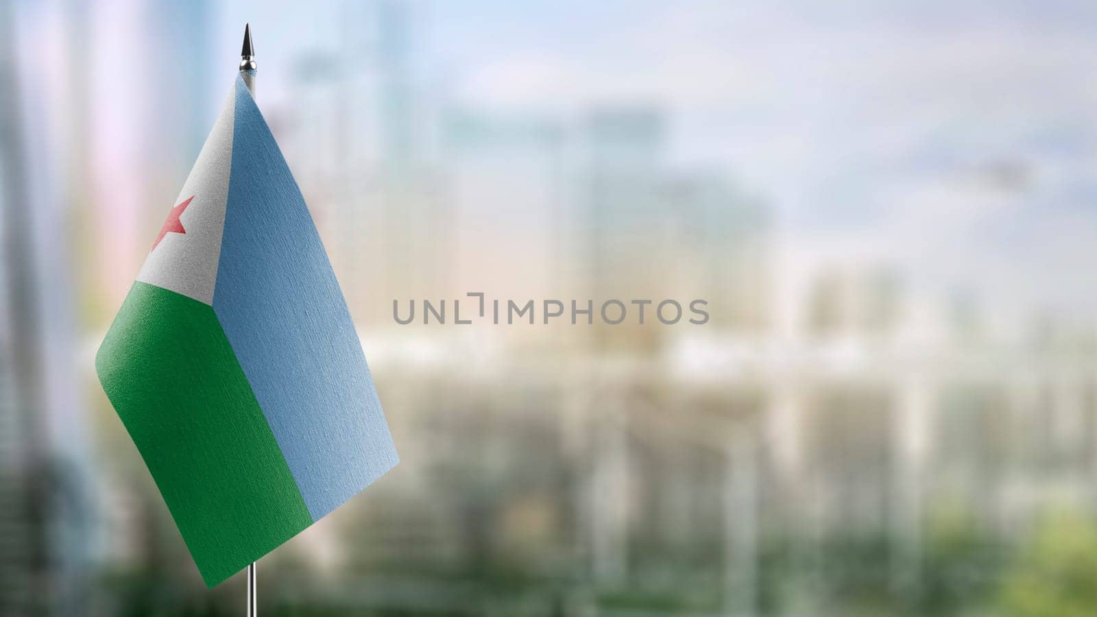 Small flags of the Djibouti on an abstract blurry background.