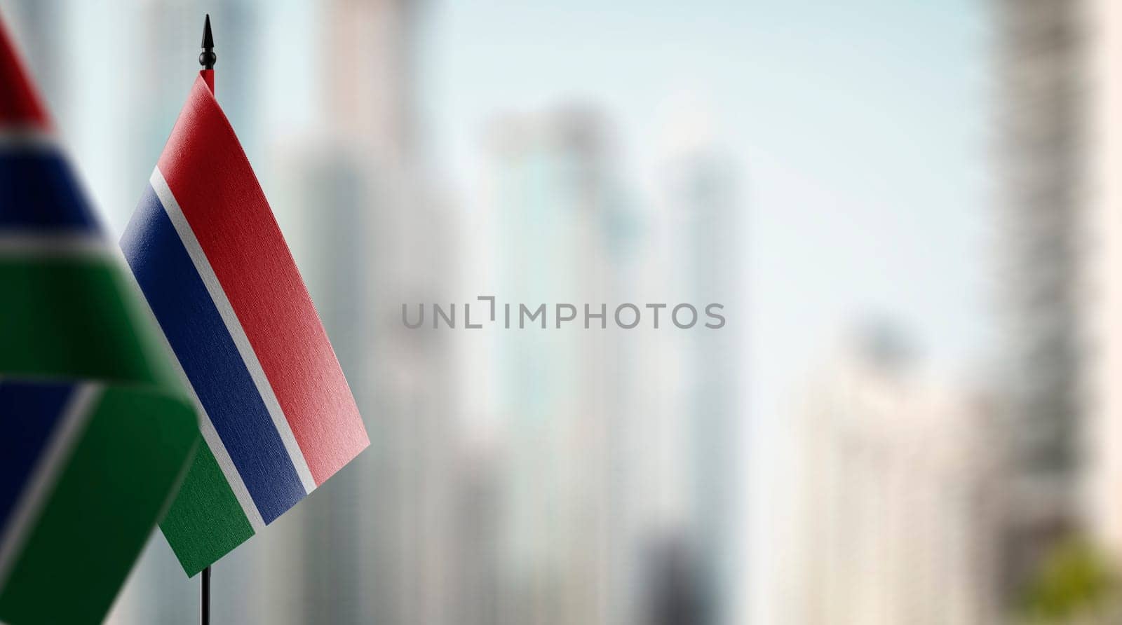 Small flags of the Gambia on an abstract blurry background by butenkow
