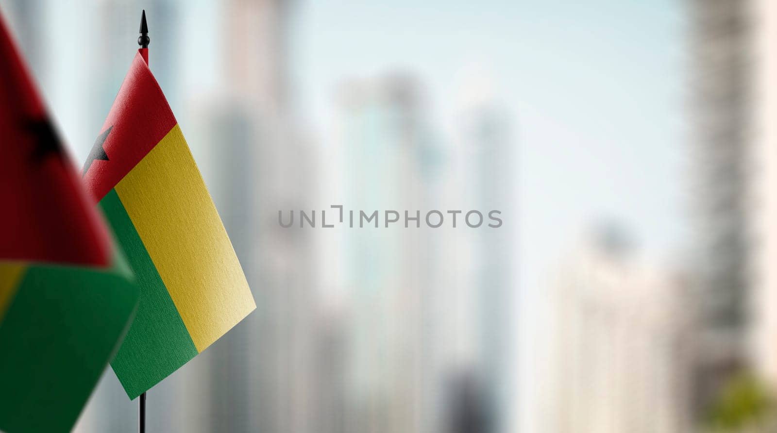 Small flags of the Guinea Bissau on an abstract blurry background.