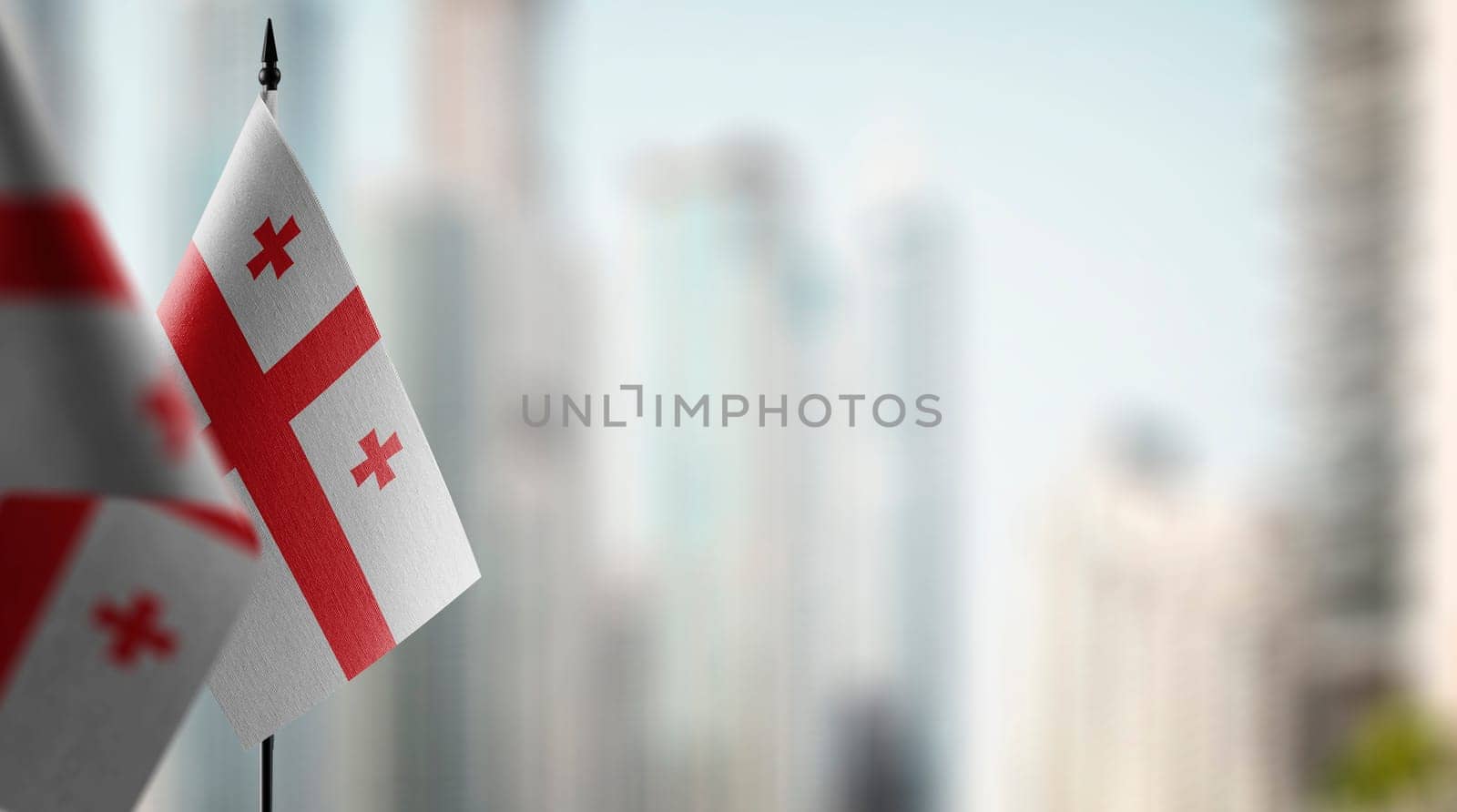 Small flags of the Georgia on an abstract blurry background by butenkow