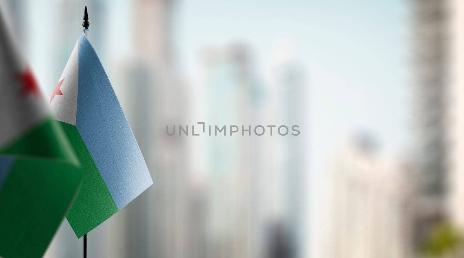 Small flags of the Djibouti on an abstract blurry background.