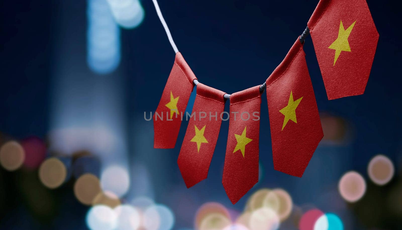 A garland of Vietnam national flags on an abstract blurred background.
