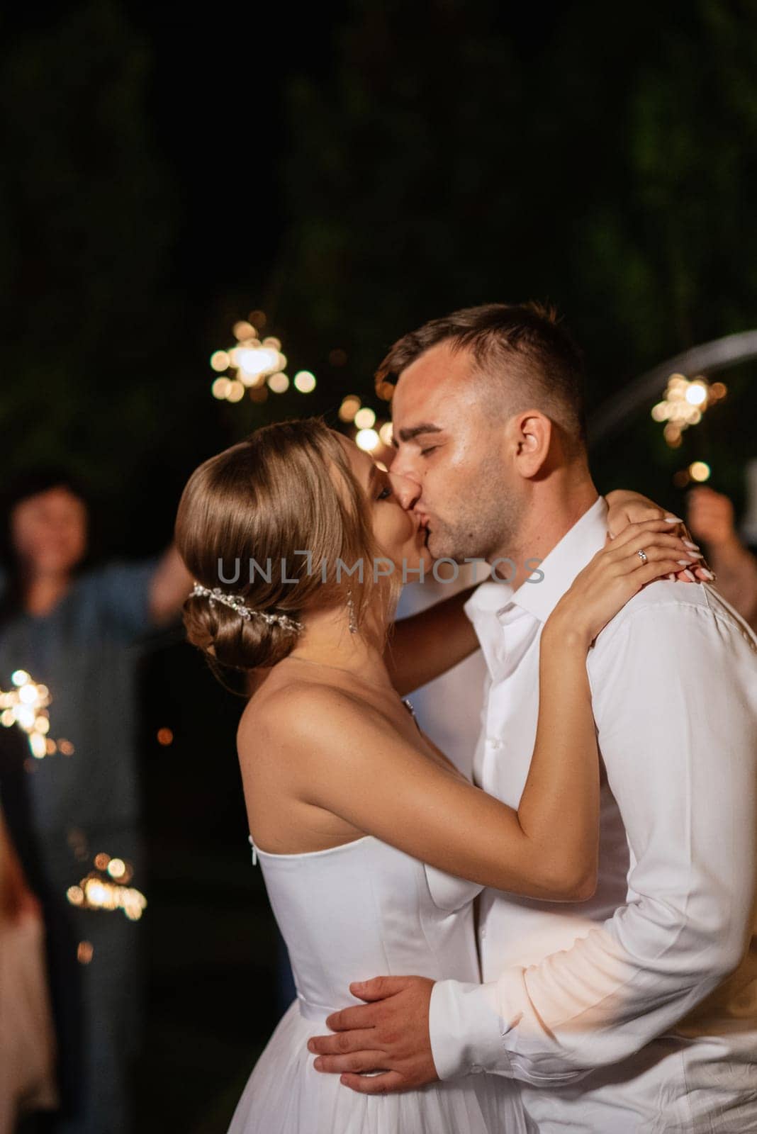 newlyweds at a wedding in the corridor of sparklers