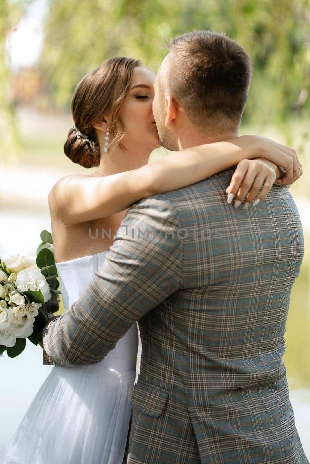 the first meeting of the bride and groom in wedding outfits in the park