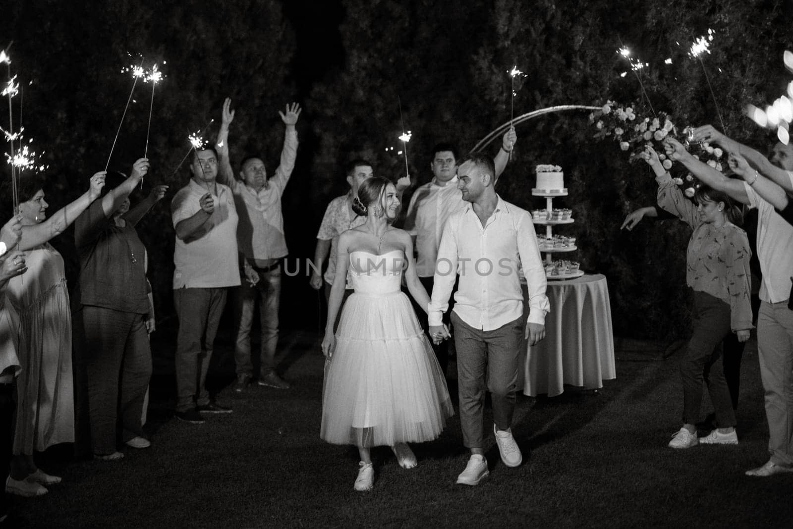 newlyweds at a wedding in the corridor of sparklers