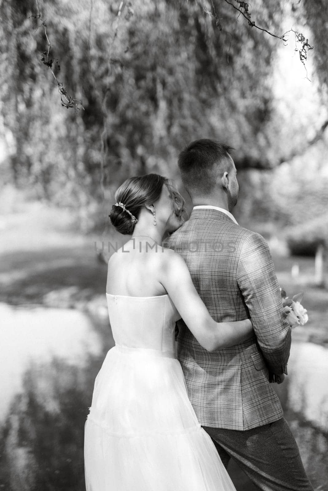 the first meeting of the bride and groom in wedding outfits in the park