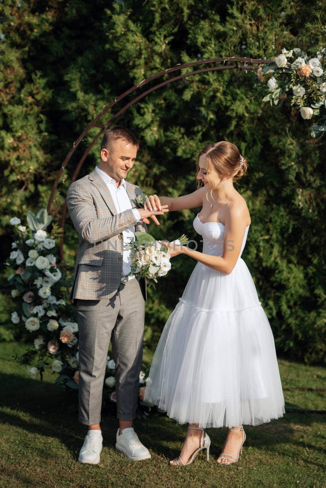 wedding ceremony of the newlyweds on the glade near the restaurant