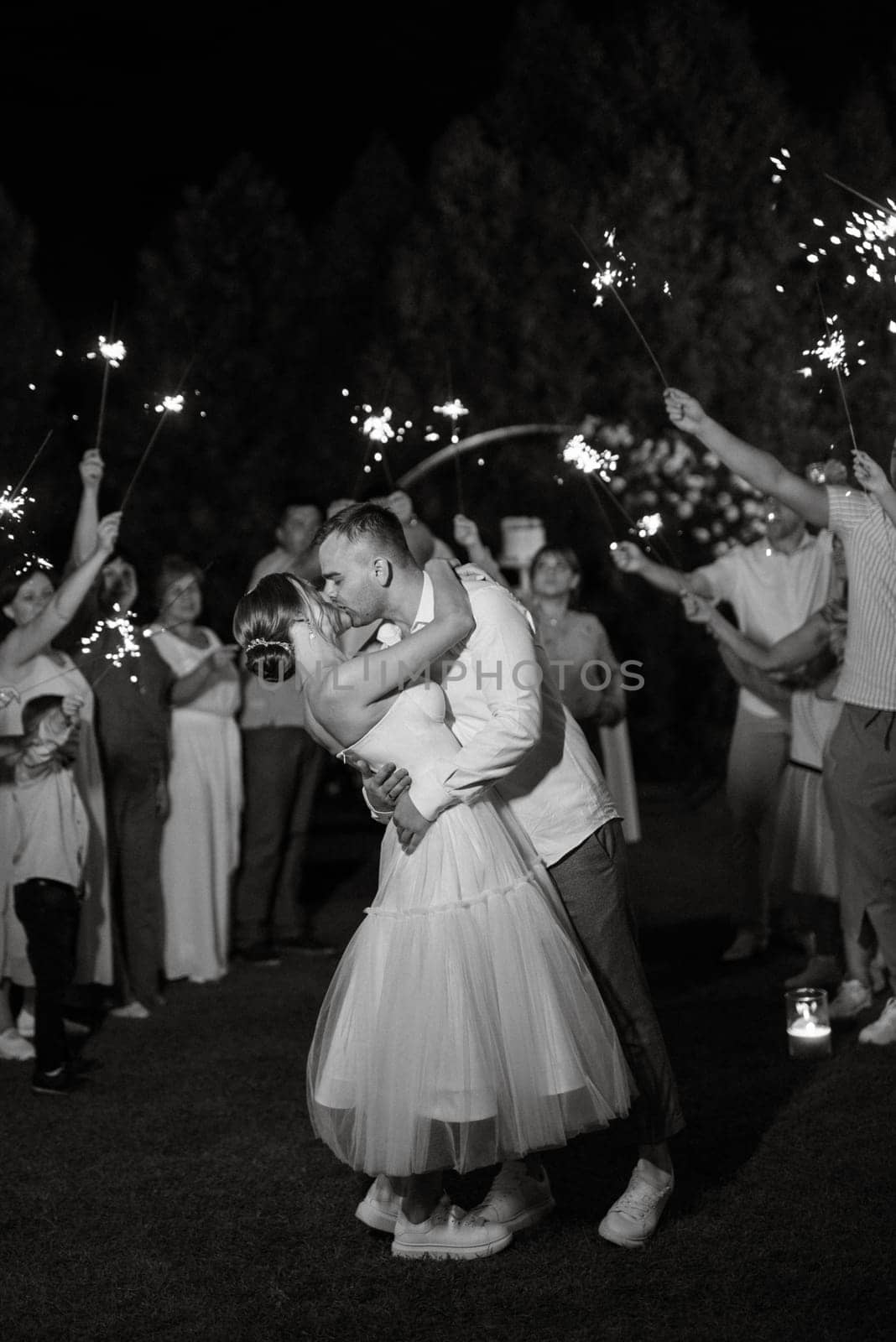 newlyweds at a wedding in the corridor of sparklers