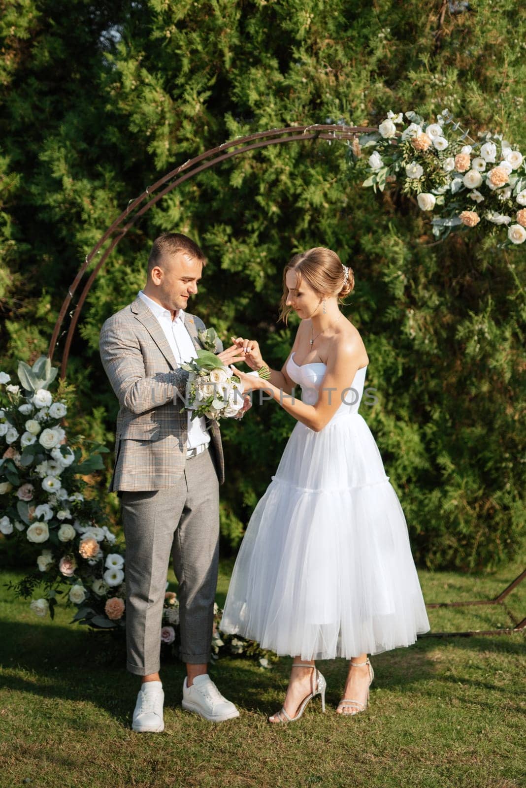 wedding ceremony of the newlyweds on the glade near the restaurant