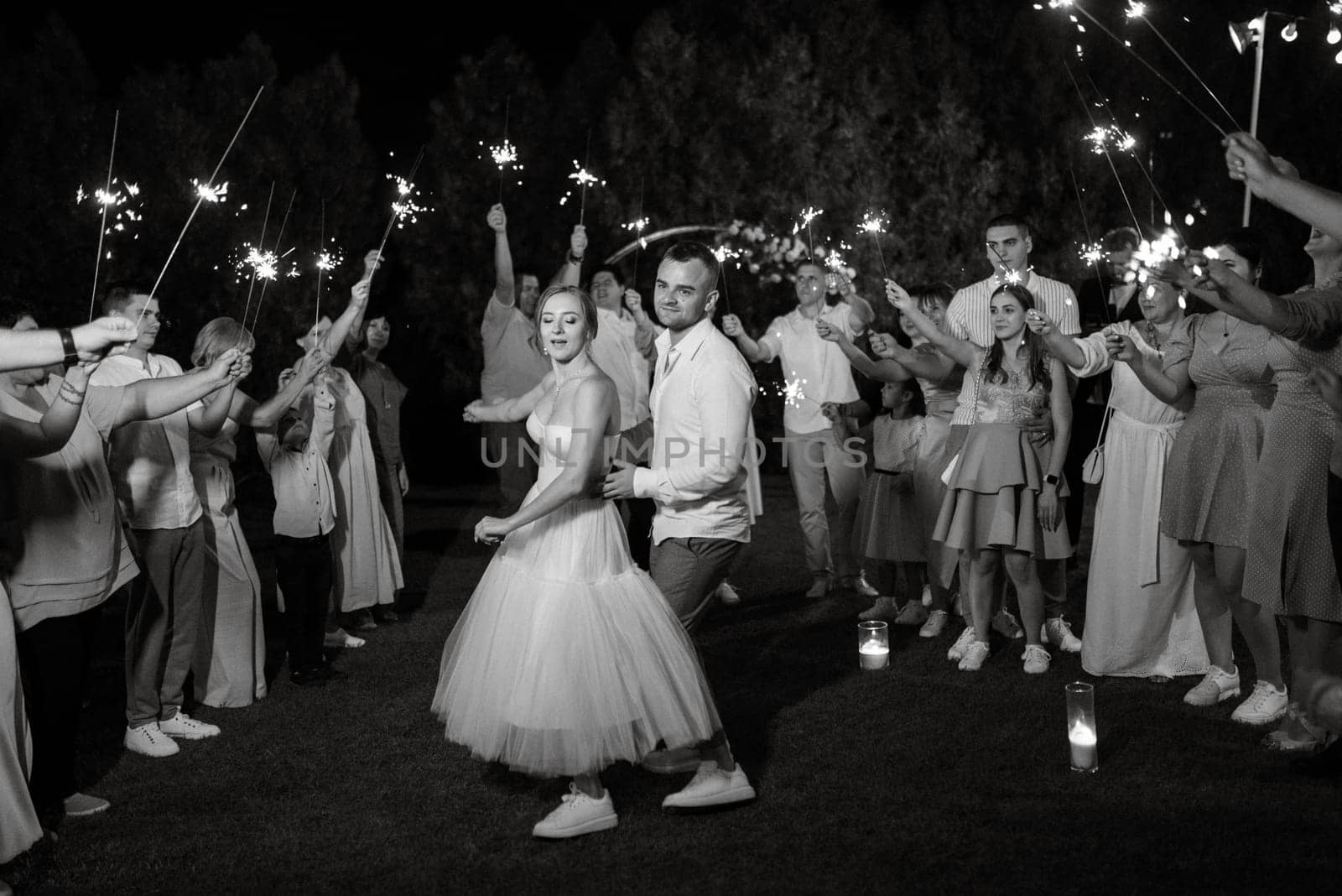 newlyweds at a wedding in the corridor of sparklers