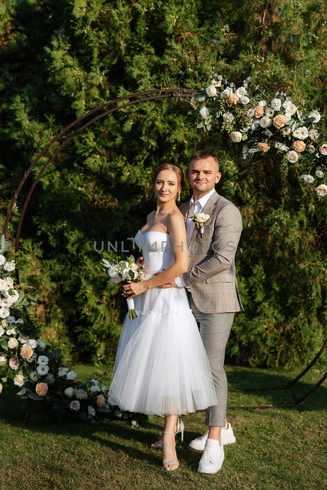 wedding ceremony of the newlyweds on the glade near the restaurant