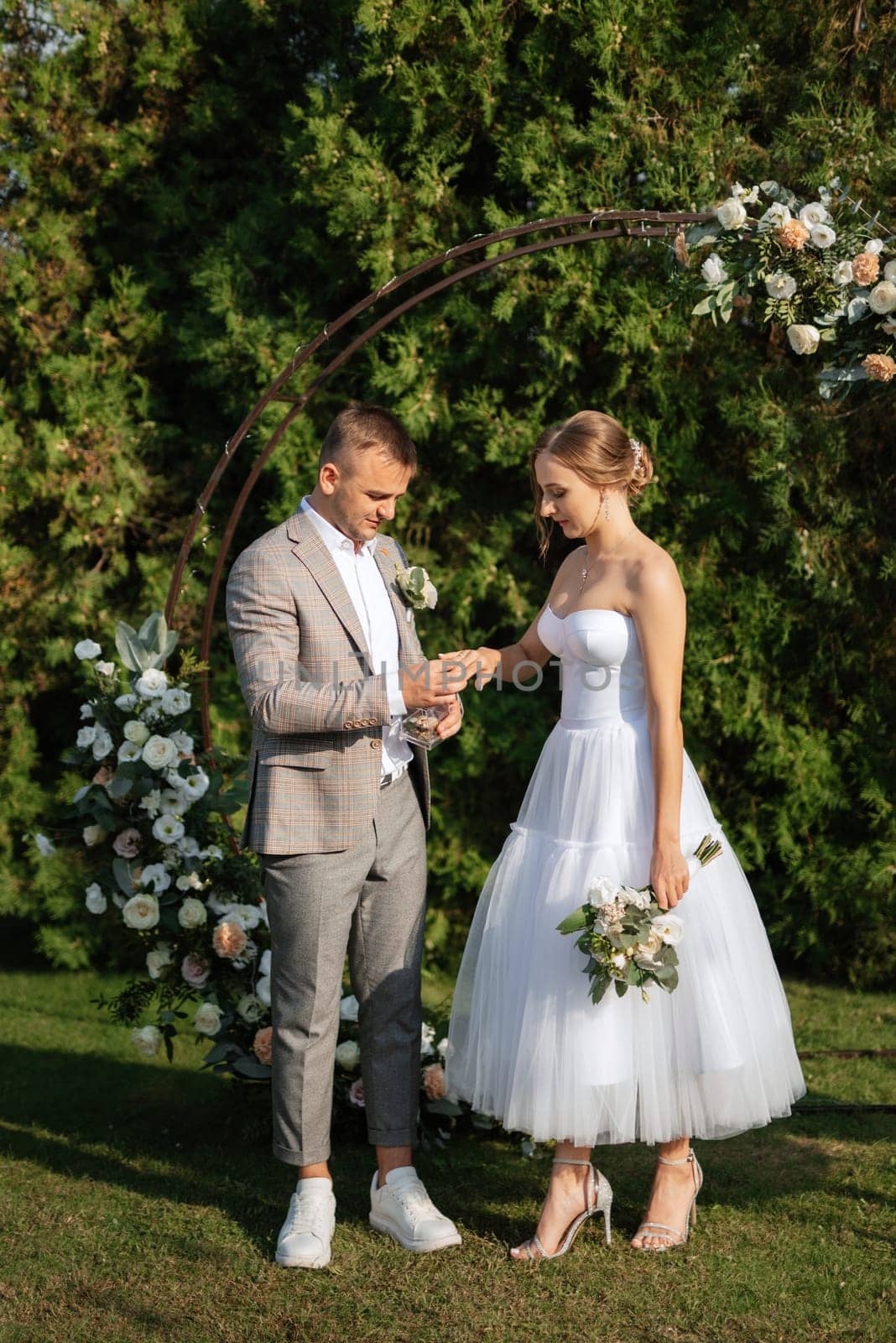 wedding ceremony of the newlyweds on the glade near the restaurant