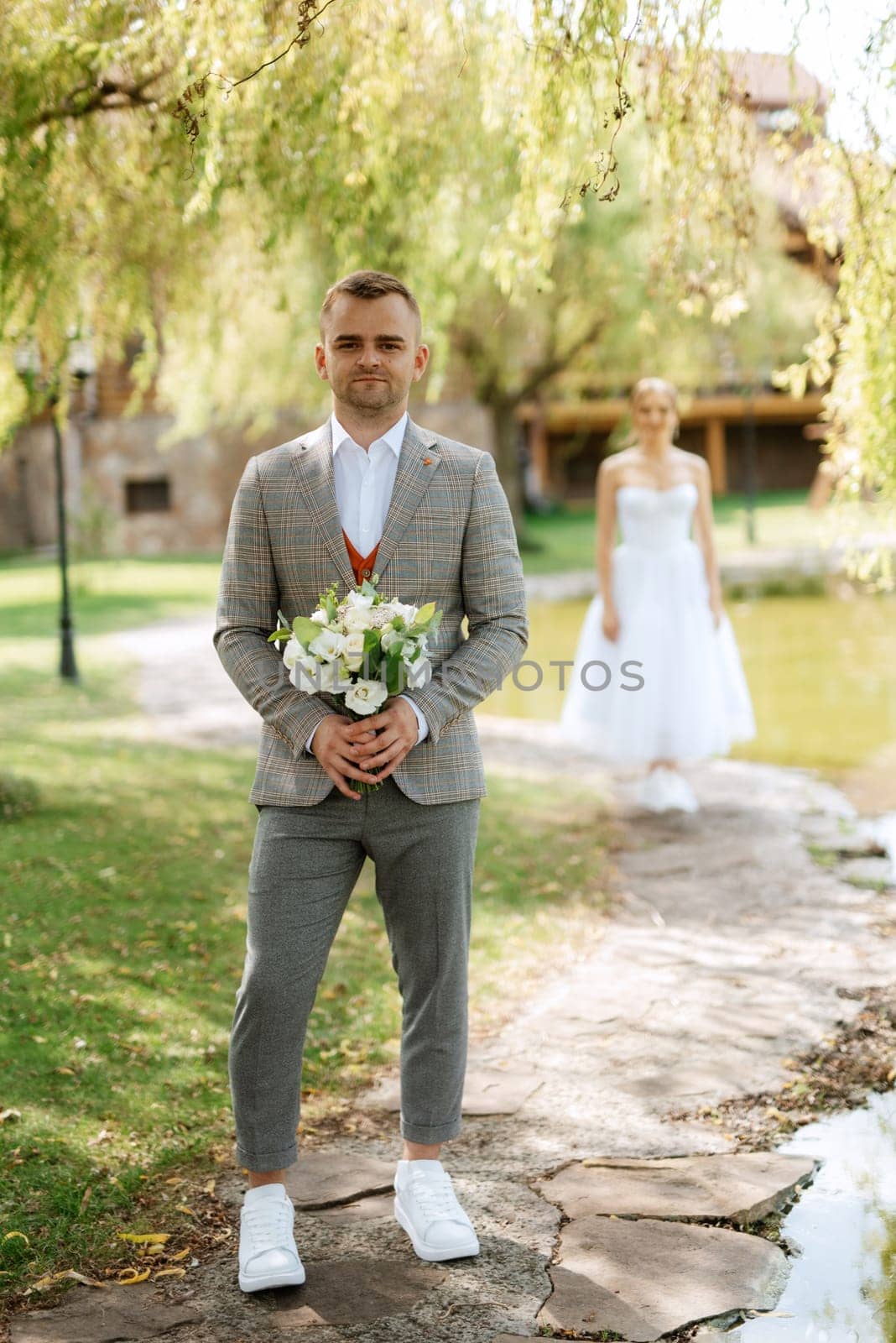 the first meeting of the bride and groom in wedding outfits in the park