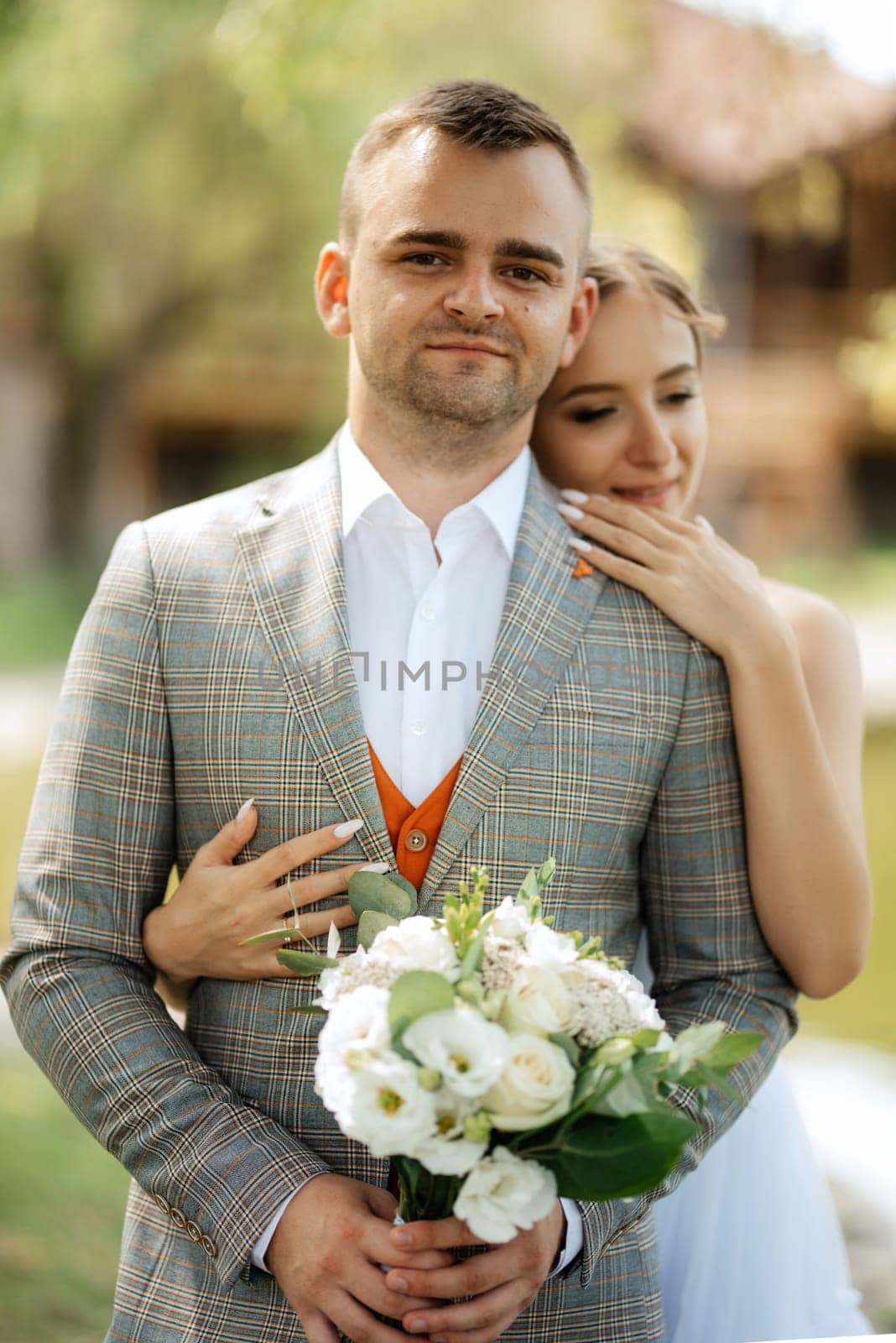 the first meeting of the bride and groom in wedding outfits in the park