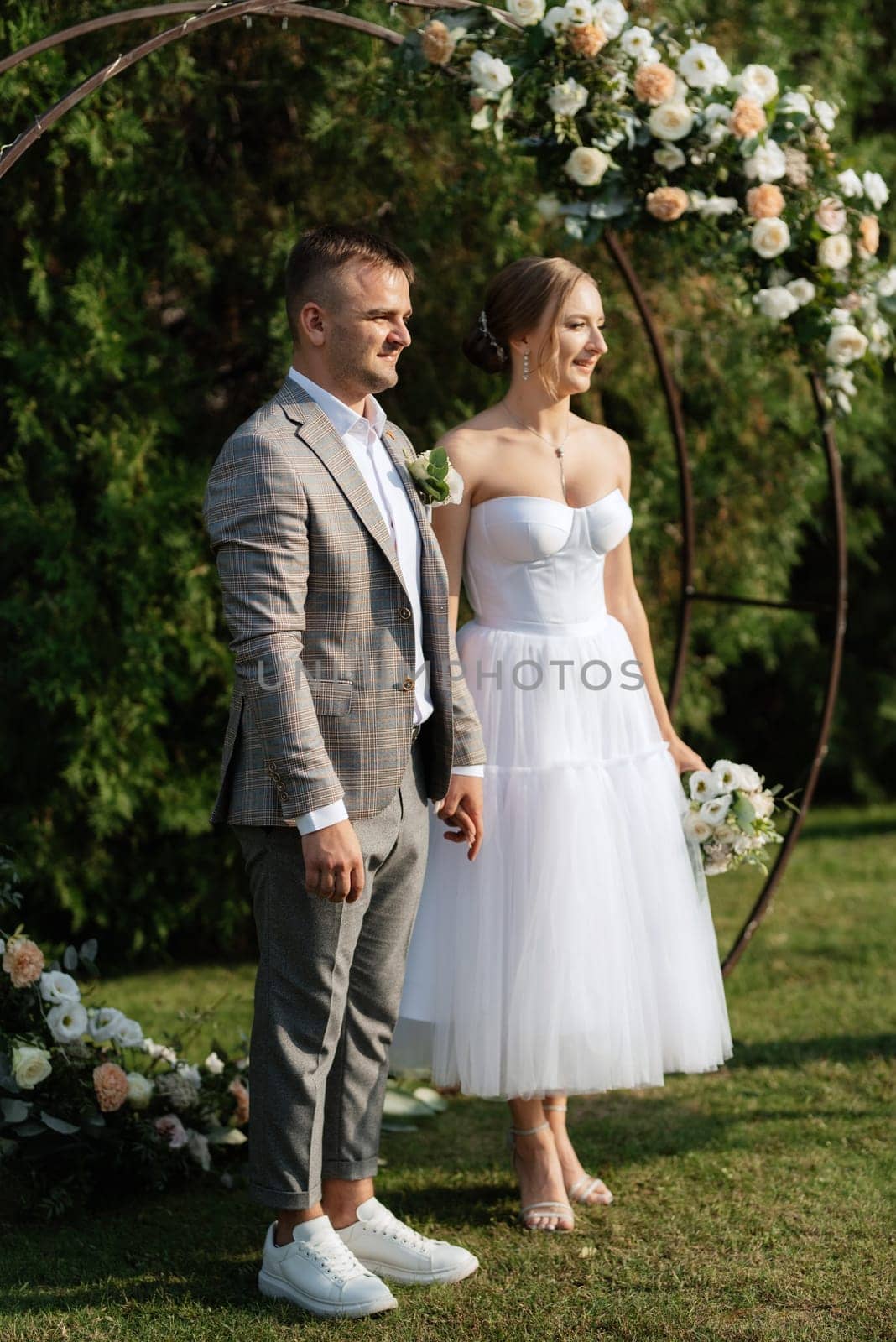 wedding ceremony of the newlyweds on the glade near the restaurant