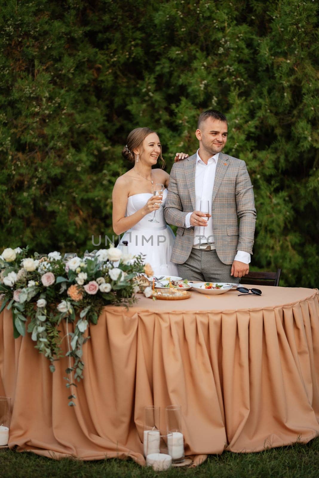 portrait of the newlyweds at the presidium at the wedding banquet