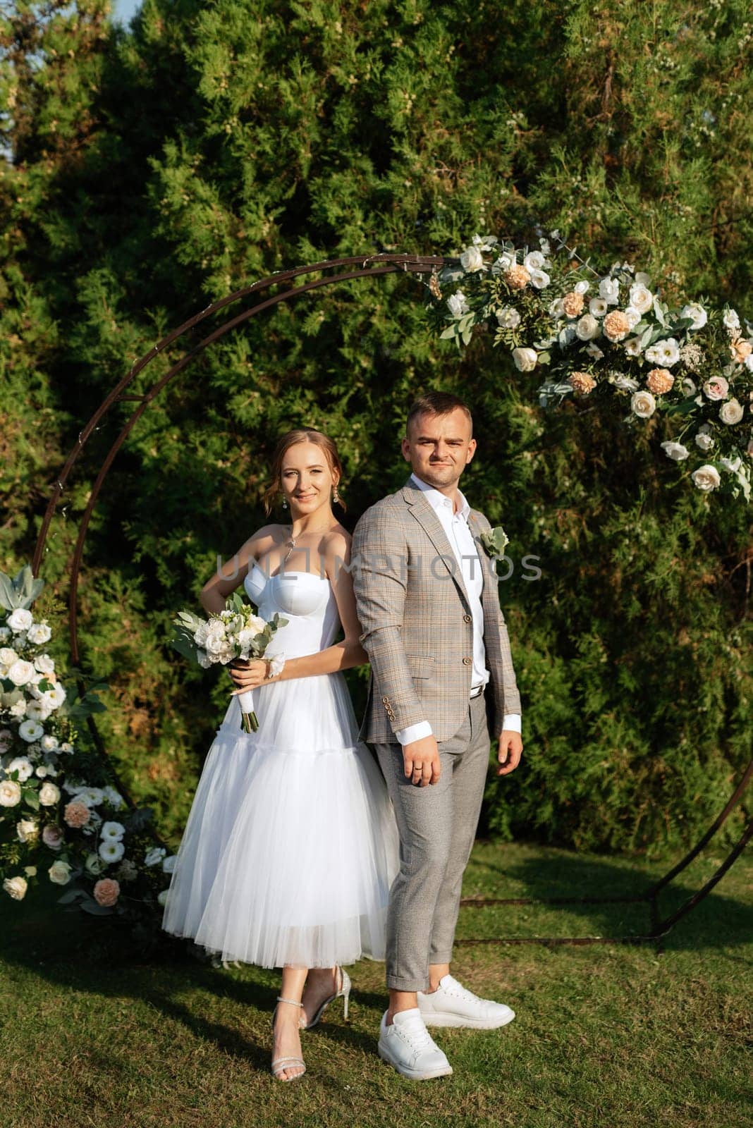 wedding ceremony of the newlyweds on the glade near the restaurant