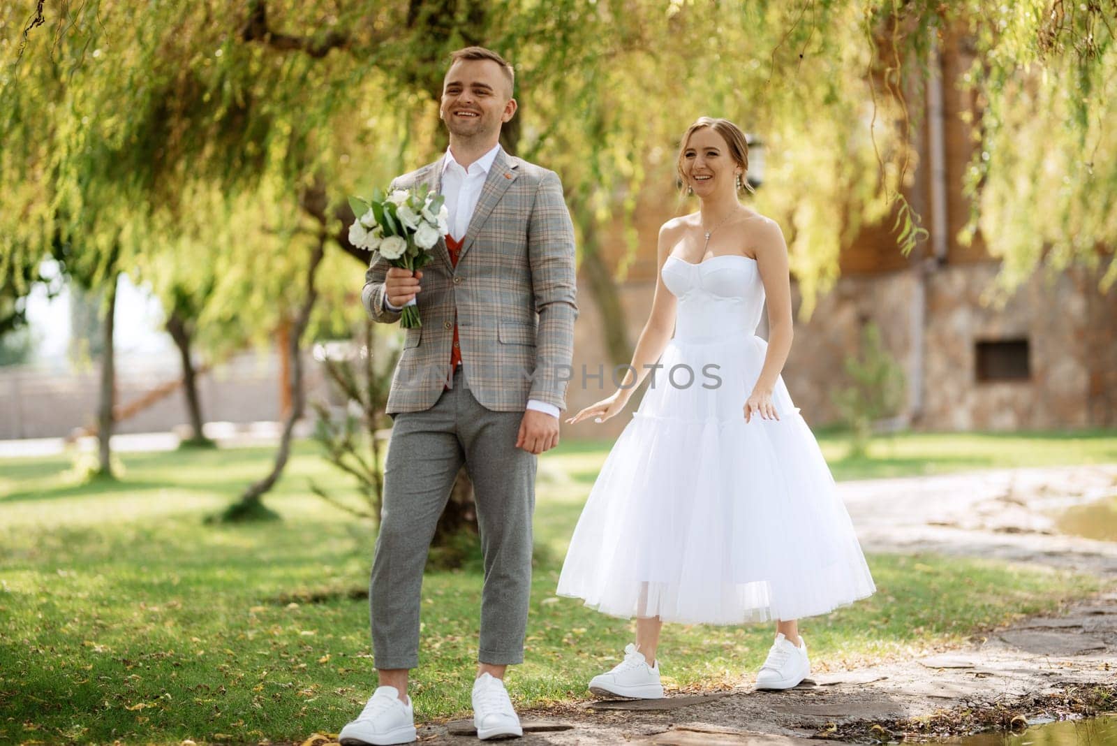 the first meeting of the bride and groom in wedding outfits in the park