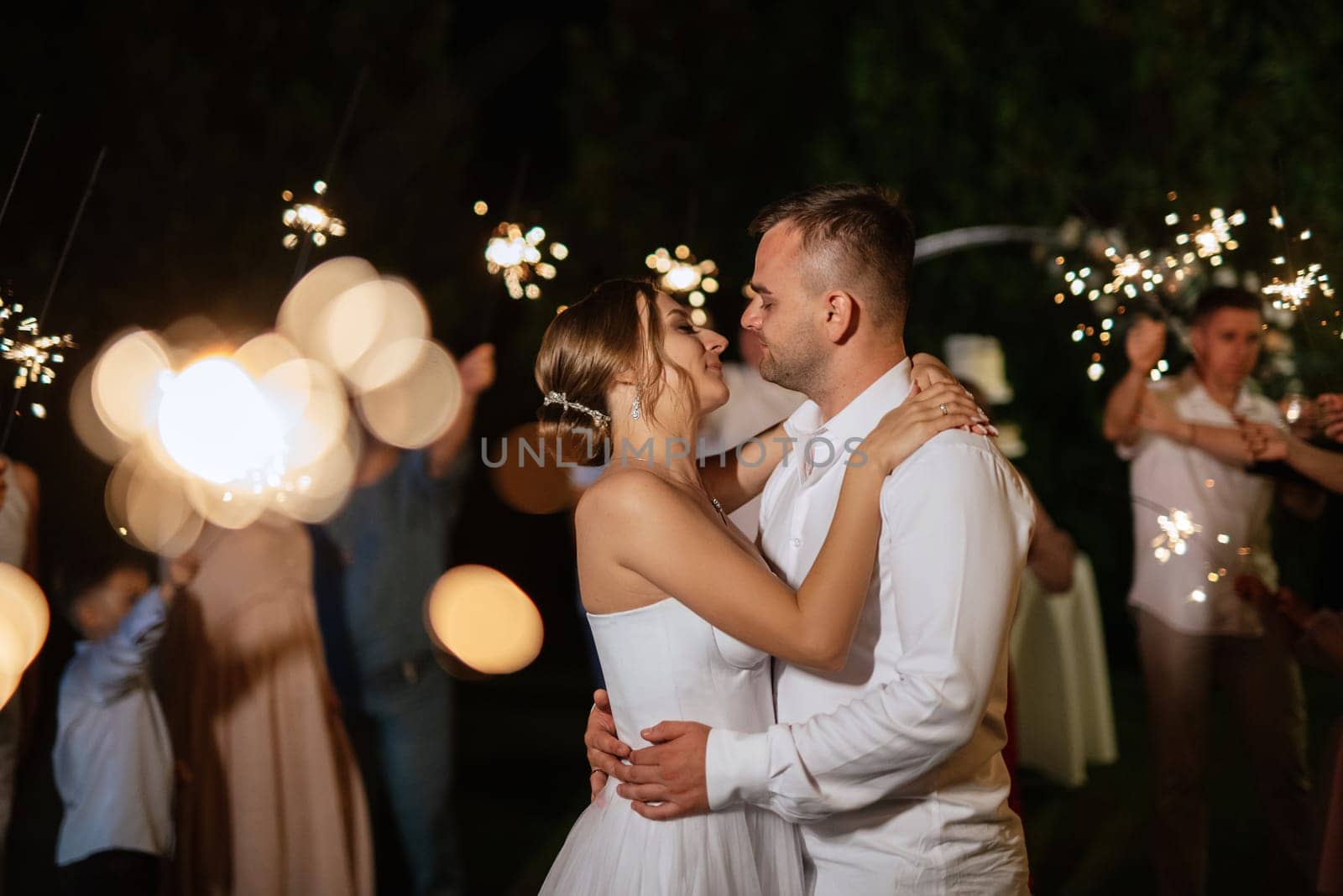 newlyweds at a wedding in the corridor of sparklers