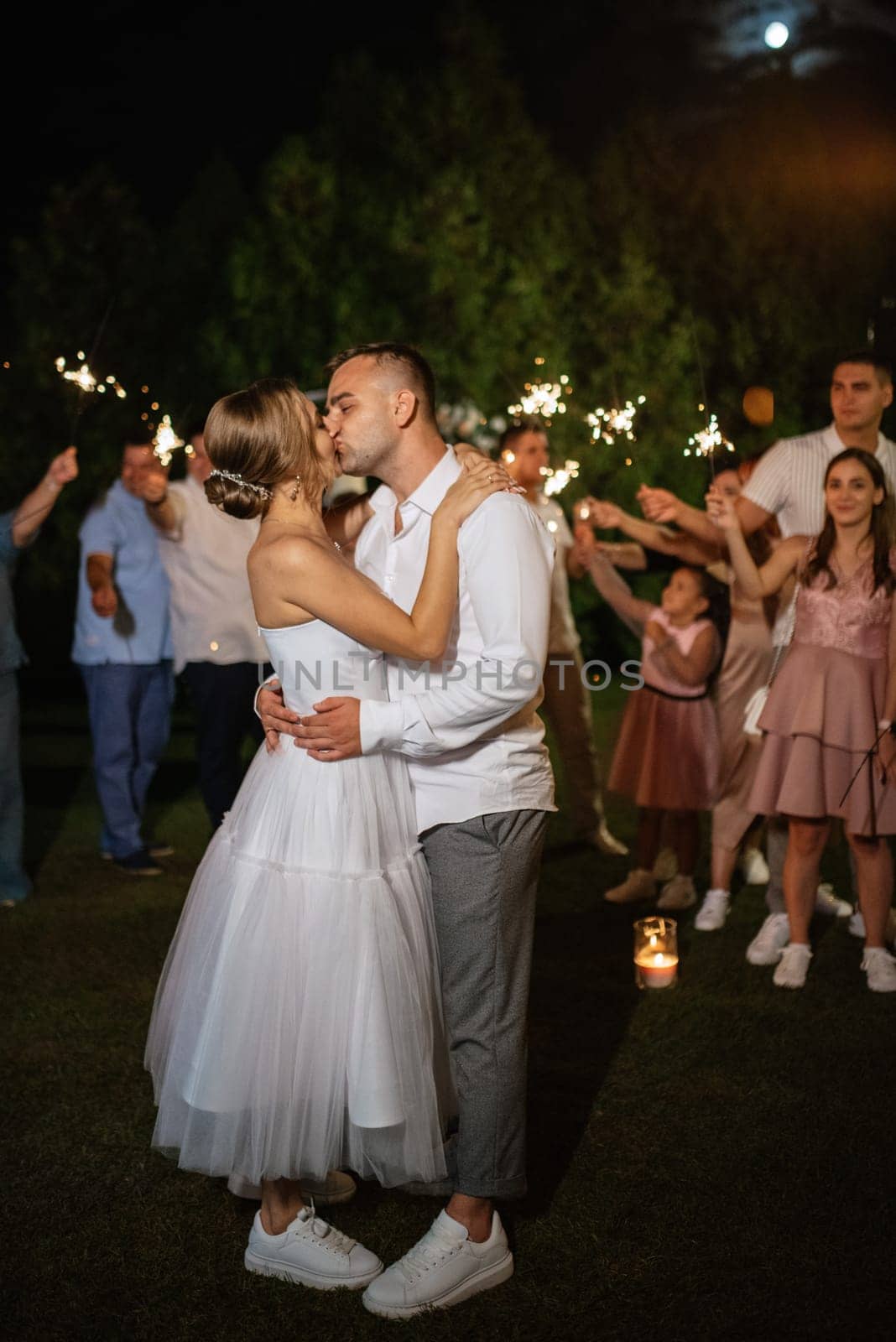 newlyweds at a wedding in the corridor of sparklers