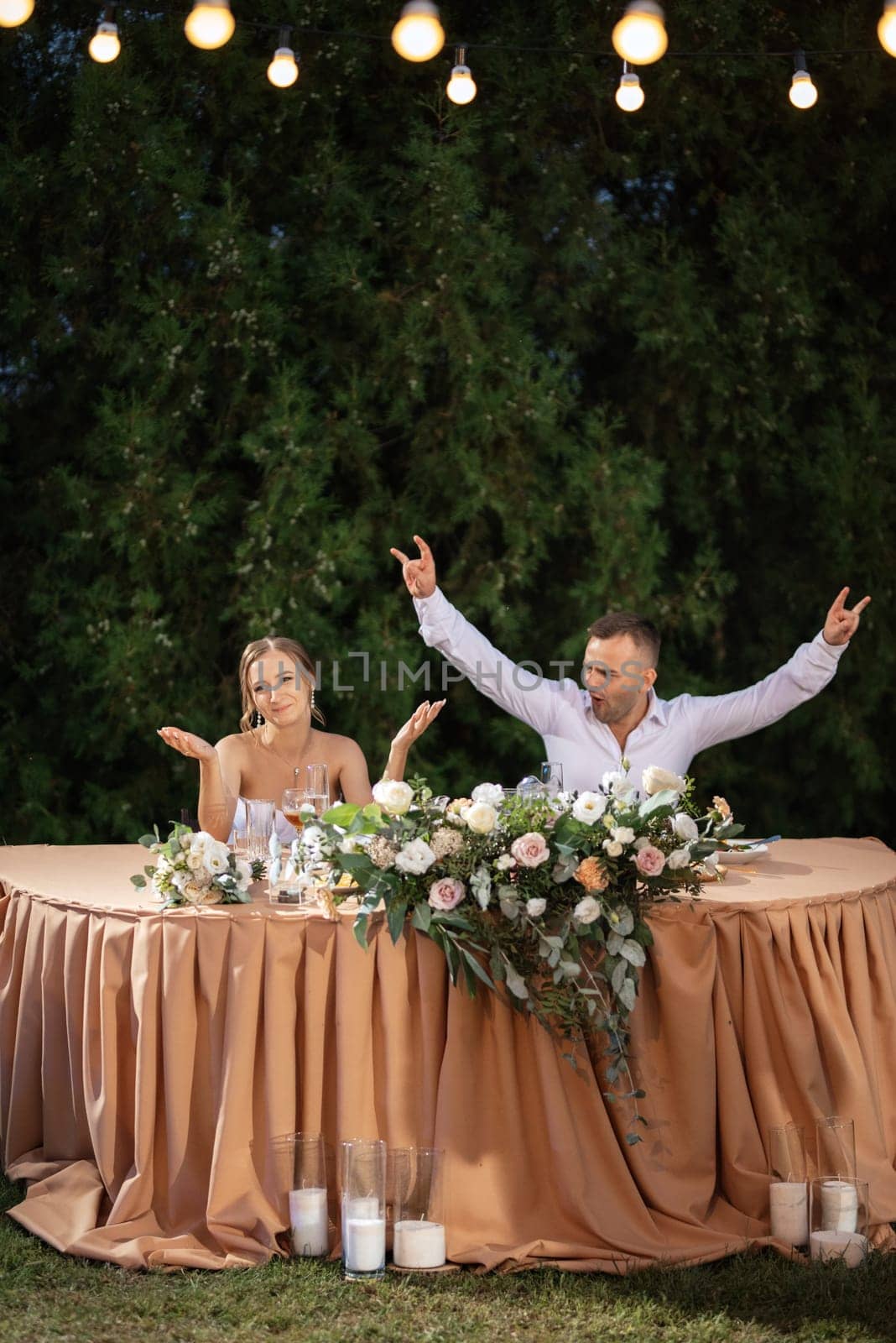 portrait of the newlyweds at the presidium at the wedding banquet