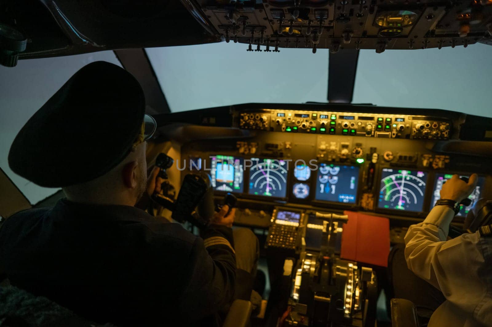 A man is studying to be a pilot in an aircraft simulator