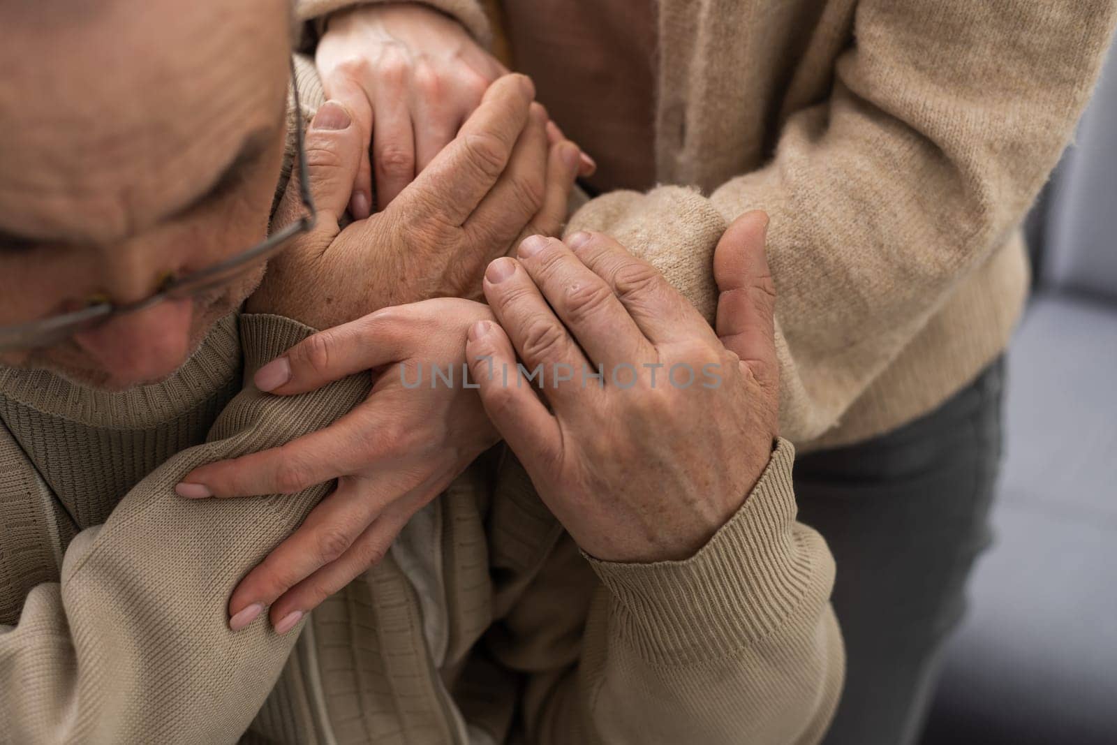 Two people holding hand together. elderly man and support woman by Andelov13