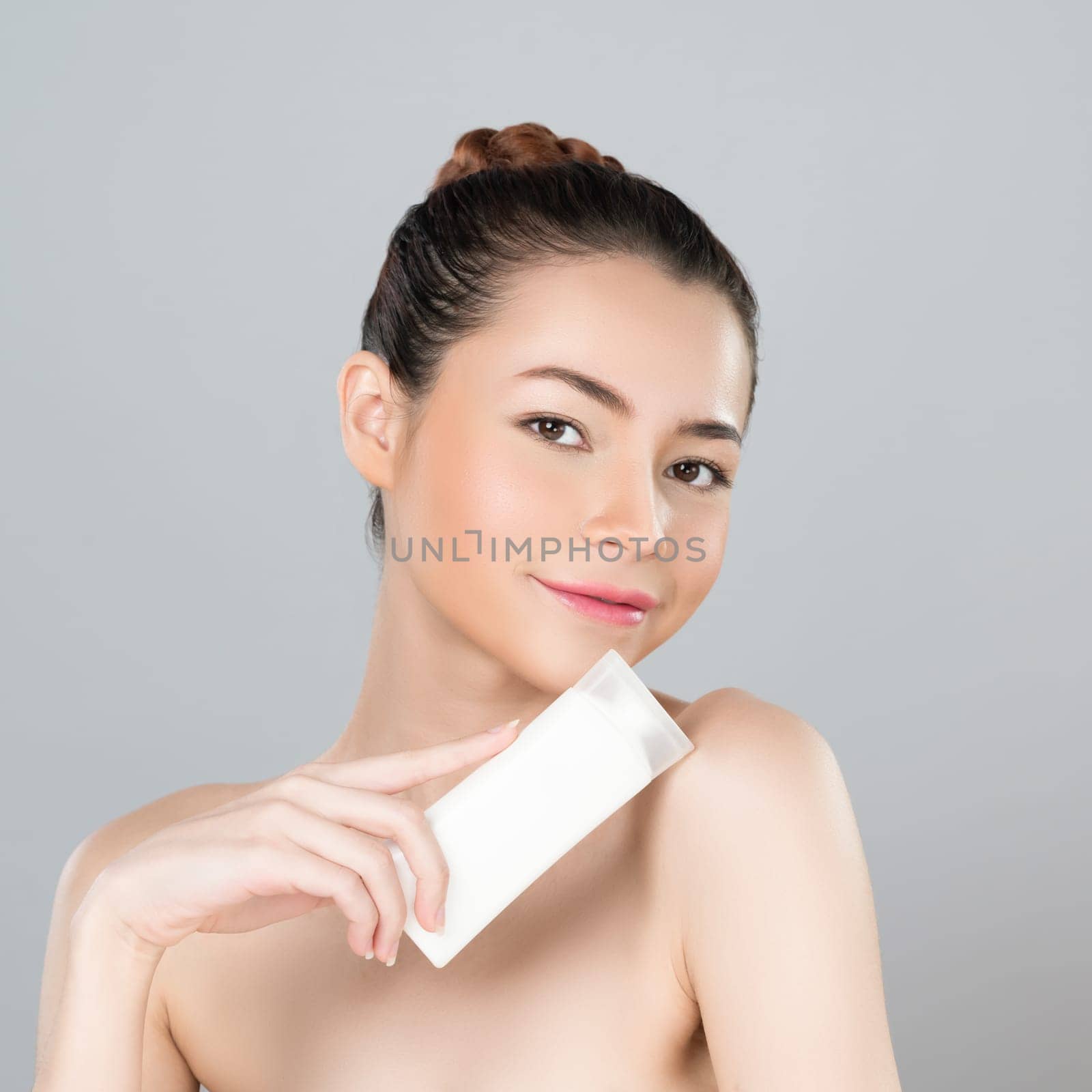 Glamorous perfect skin woman holding mockup moisturizer tube. by biancoblue