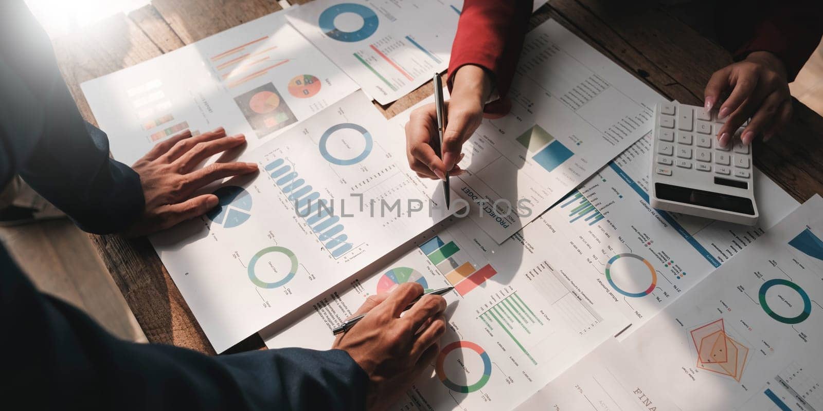 Business People Meeting using laptop computer,calculator,notebook,stock market chart paper for analysis Plans to improve quality next month. Conference Discussion Corporate Concept....