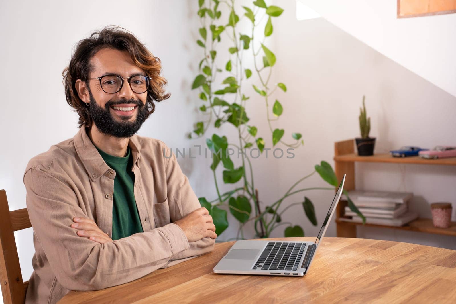 Cheerful male looking at camera in a small business home office. Portrait of a freelancer. by PaulCarr