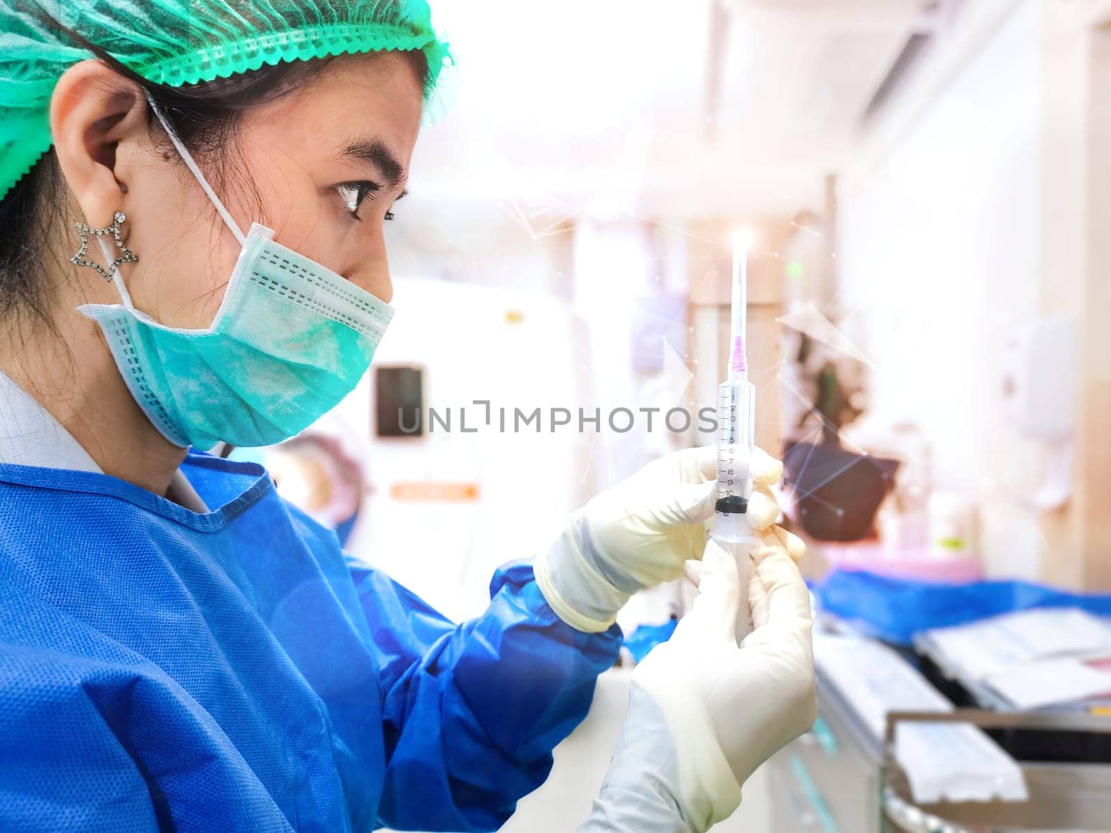 Woman Doctor with Safety PPE gown protective workwear holding Vaccine and syringe on CT Scan room background. Female doctor with face mask gloves in Hospital, preparing vaccine.