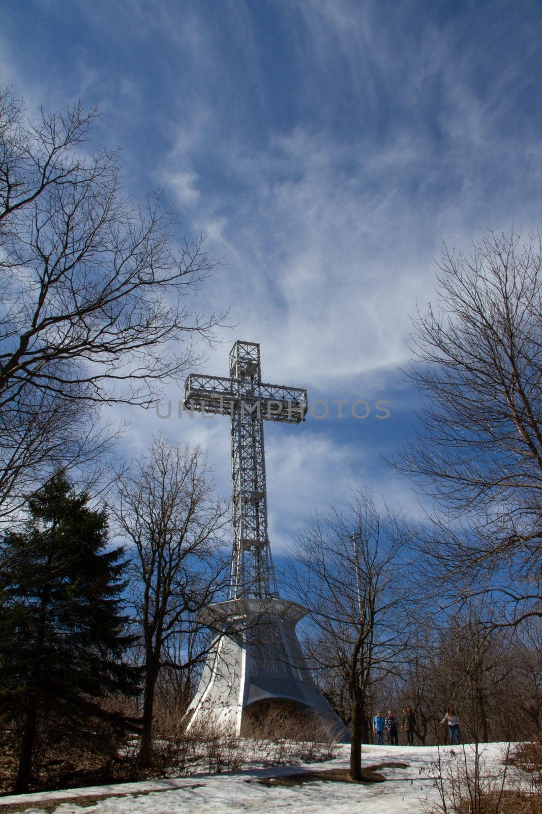 The Mount Royal Cross, built in 1924, surrounded by trees and snow in late winter by Granchinho