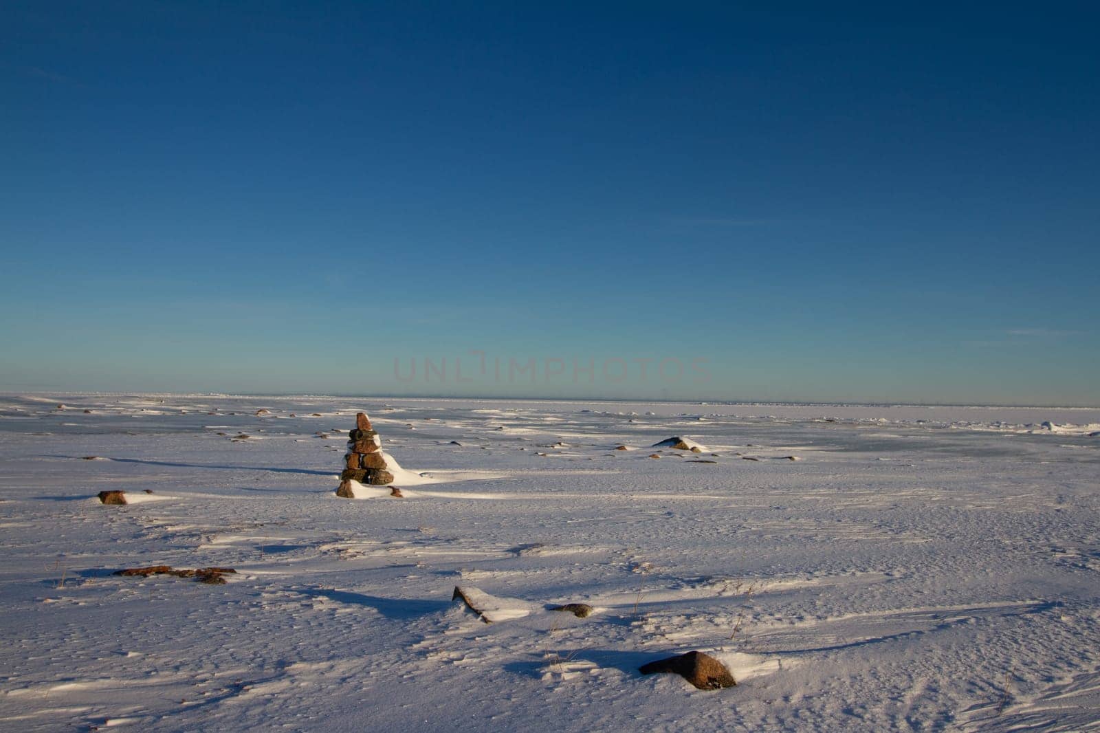 Frozen arctic landscape with snow on the ground near Arviat, Nunavut by Granchinho
