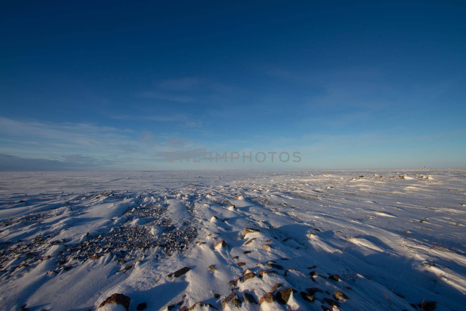 Frozen arctic landscape with snow on the ground near Arviat, Nunavut, Canada