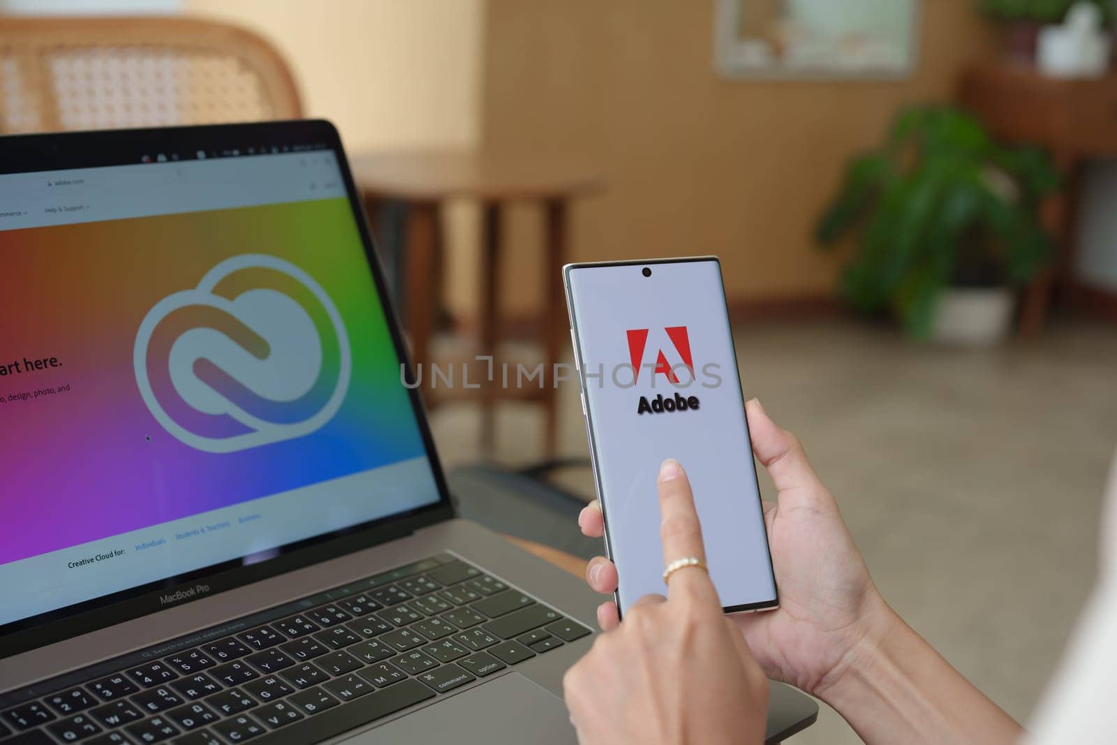 Chiang Mai Thailand. Jul 09, 2022. woman holding mobile phone to open adobe creative cloud to create work, photo, video, template, pdf