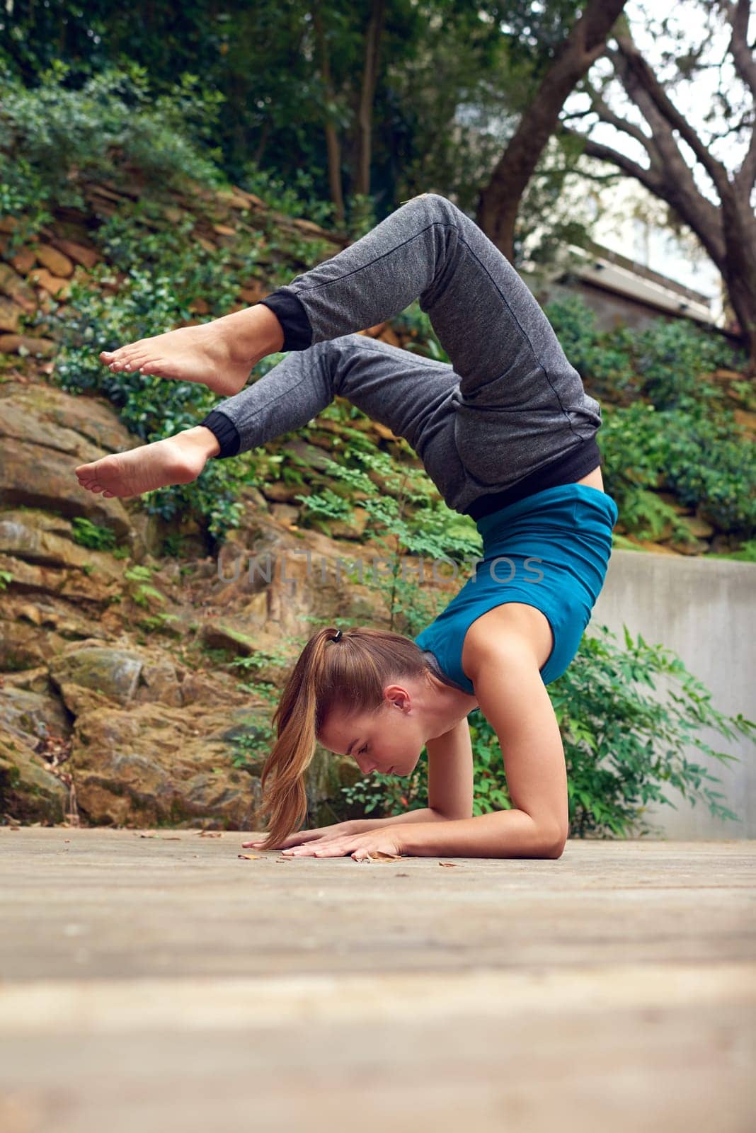 Looking at life from a different angle. a young woman practicing yoga outdoors