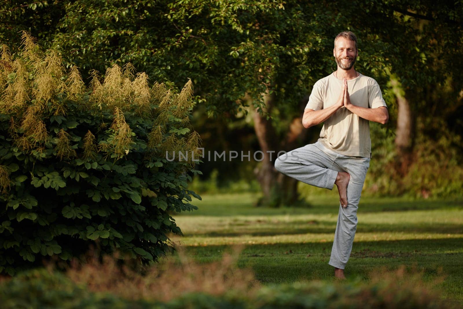 Yoga works for me. Portrait of a handsome mature man enjoying a yoga session in nature. by YuriArcurs