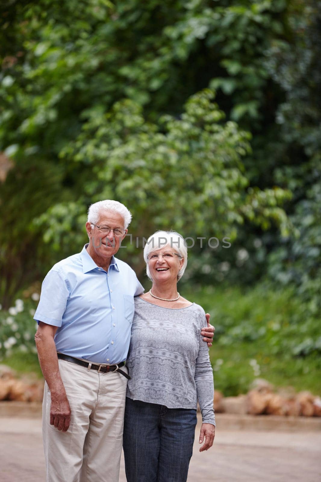 We stay in love by choice. a happy senior couple standing outdoors while smiling at the camera