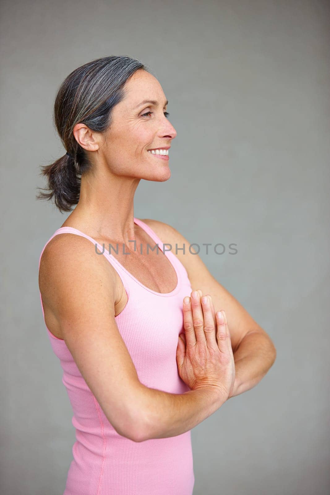 Your body is your temple. an attractive mature woman doing yoga outdoors
