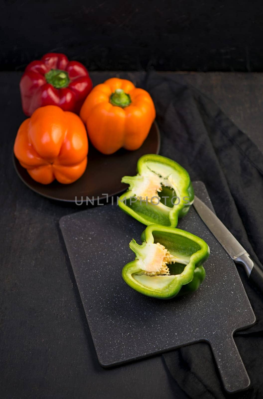 sweet pepper, red, green, yellow pepper on black background, full depth of field by aprilphoto