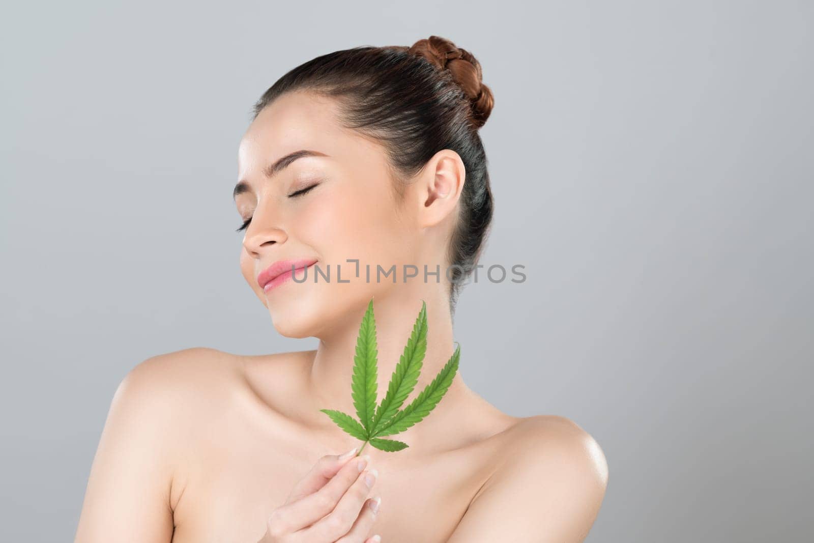 Closeup glamorous woman hold green leaf as cannabis beauty concept. by biancoblue
