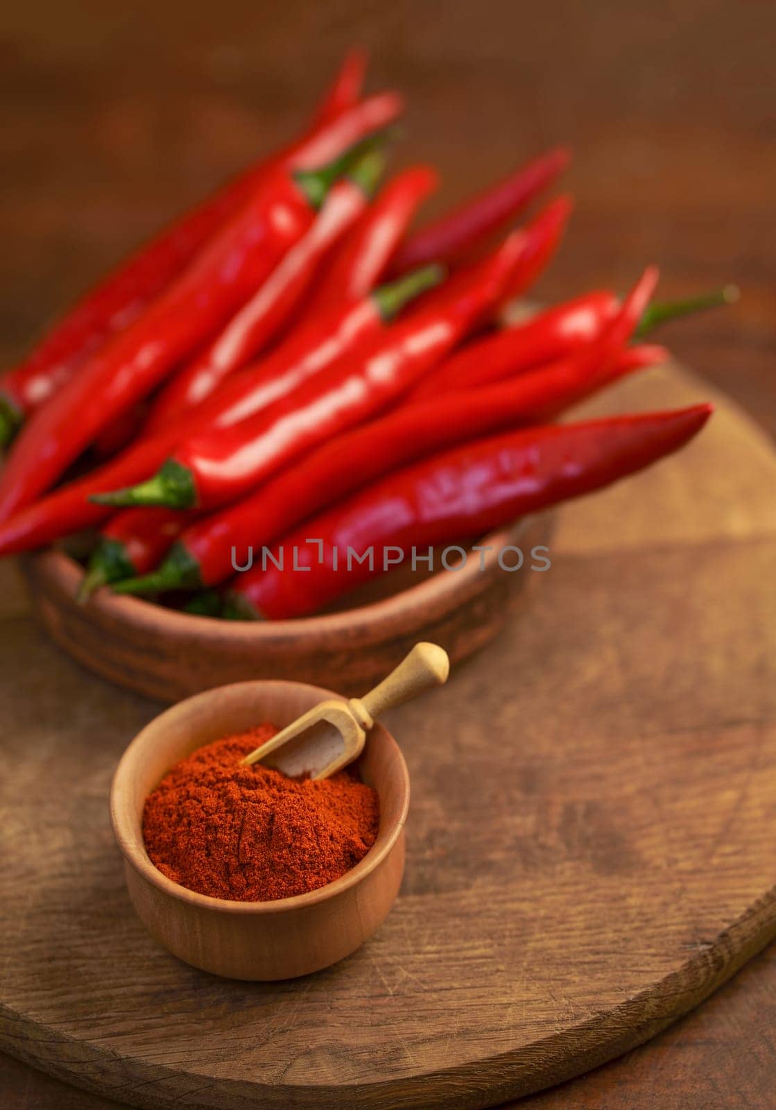 Red hot chili peppers on old wooden table with spice