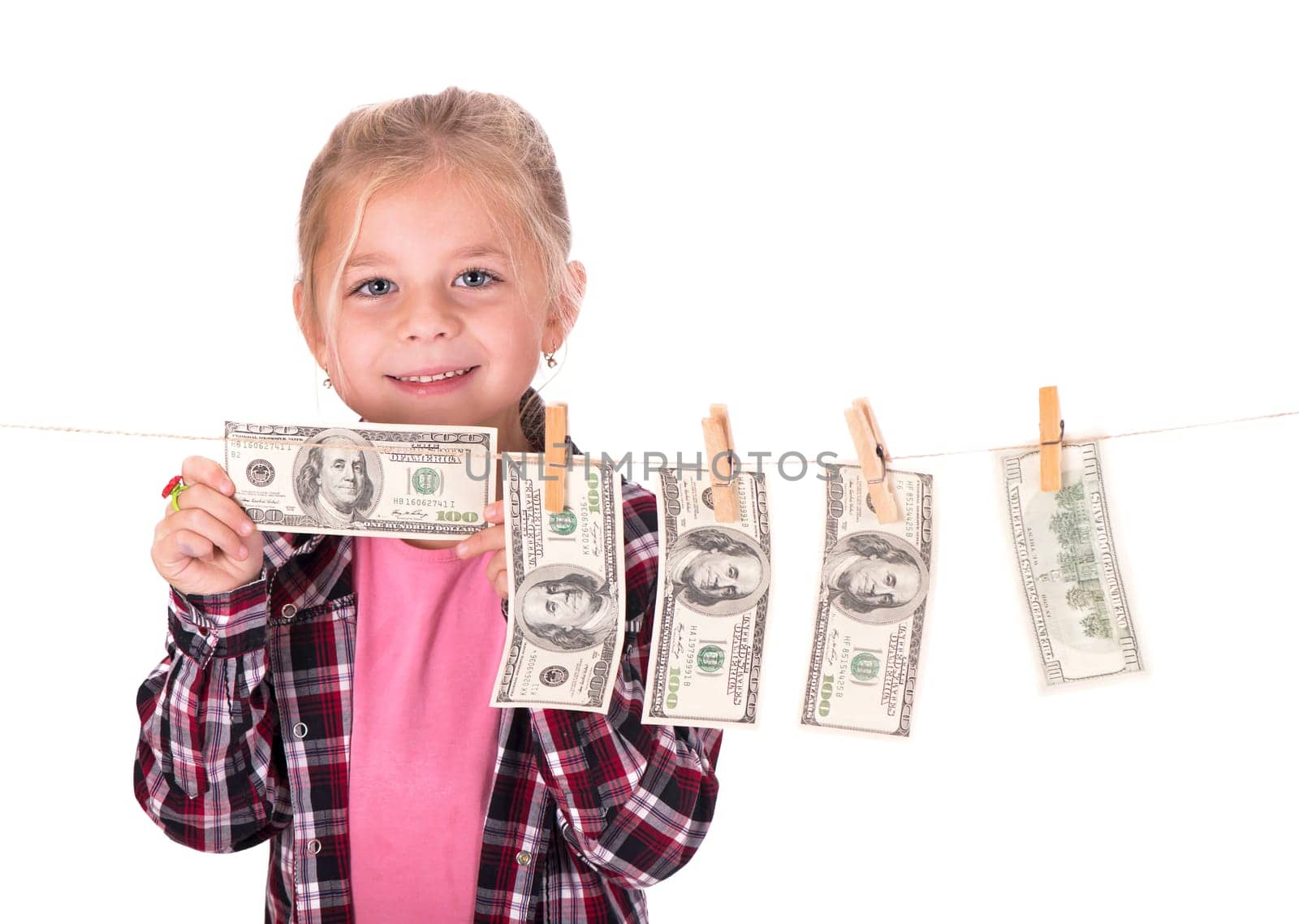 Girl hangs on the money on the rope