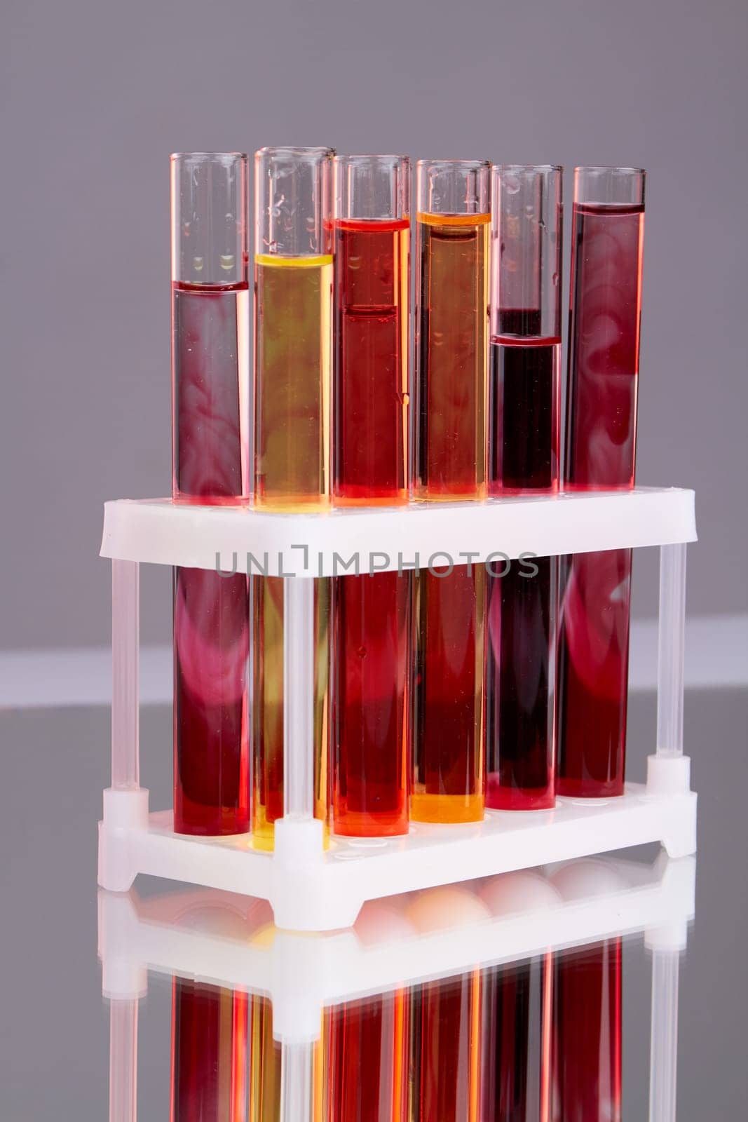Vertical shot of colorful laboratory test tubes with blood. by super_picture
