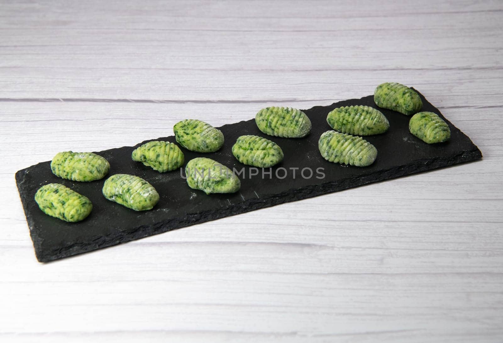 Pile of green spinach gnocchi, potato peru italian food, Homemade, High quality photo