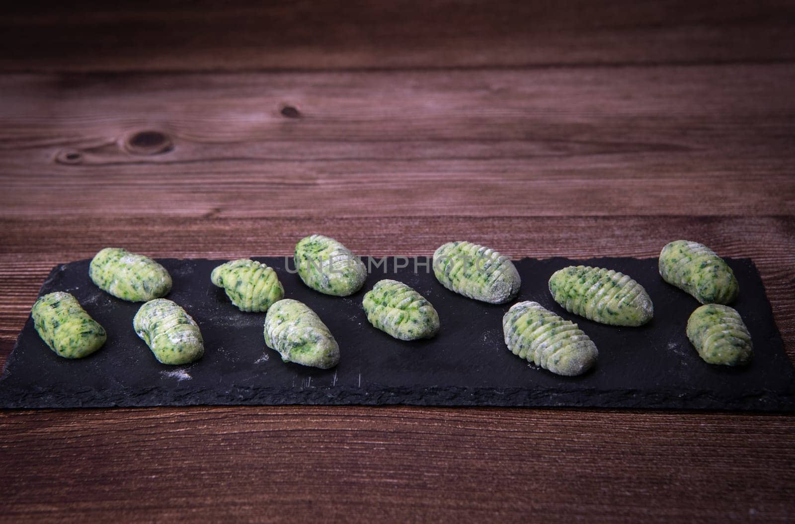 Pile of green spinach gnocchi, potato peru italian food, Homemade, High quality photo