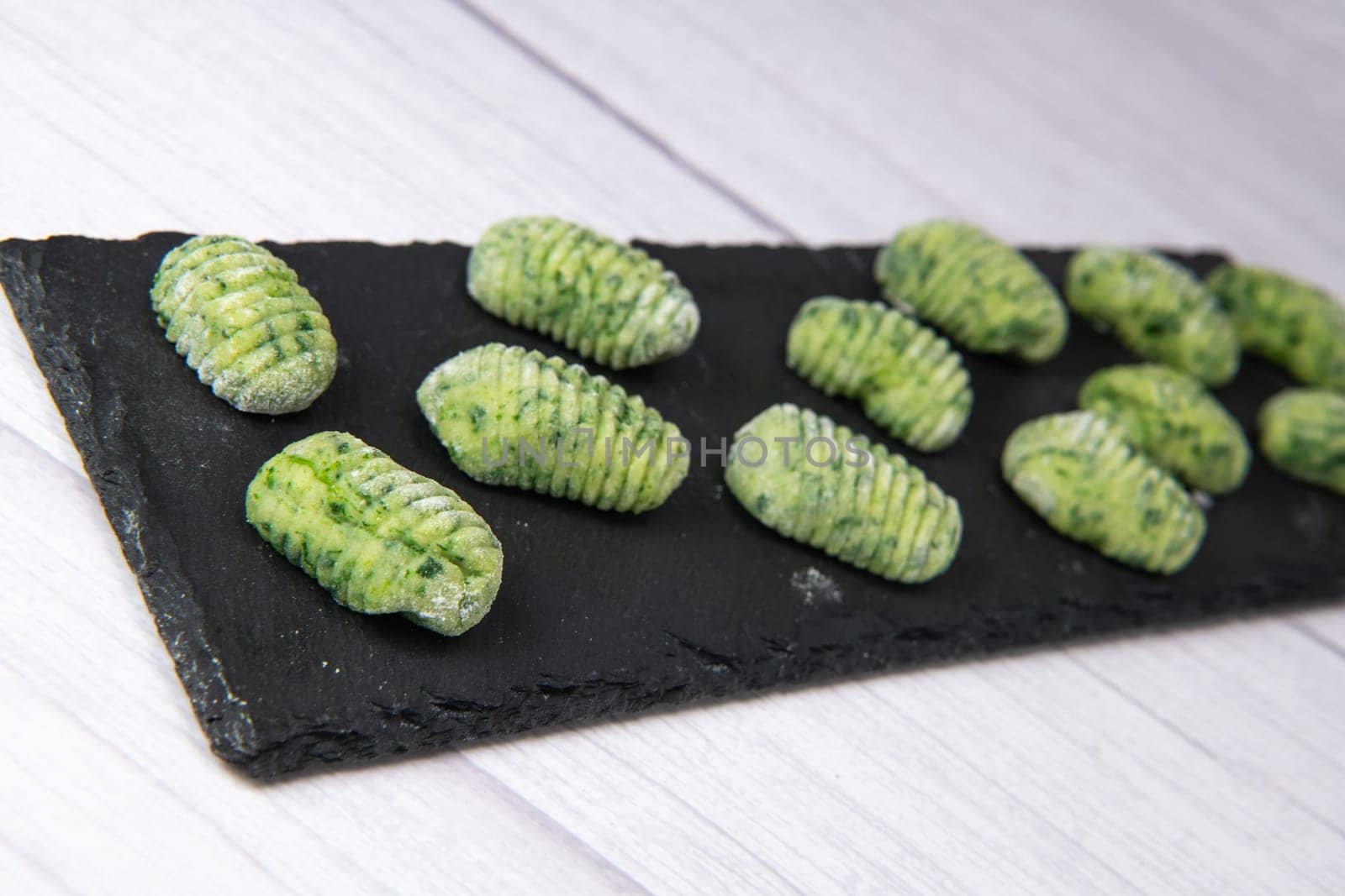 Pile of green spinach gnocchi, potato peru italian food, Homemade, High quality photo