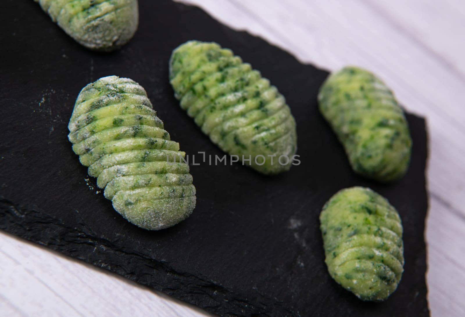 Pile of green spinach gnocchi, potato peru italian food, Homemade, High quality photo